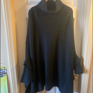 Black poncho sweater.